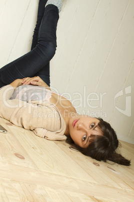Young woman lying on the floor of the house