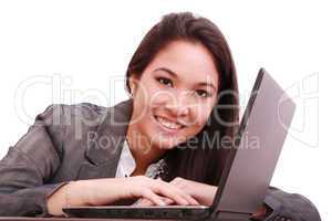 portrait of a cute smiling businesswoman working on a laptop