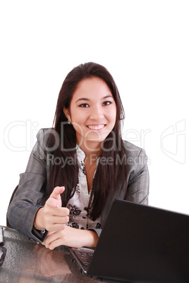 business woman sitting on chair at desk in office and pointing to you:yes,you!
