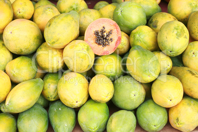 Papaya fruit cut and whole.