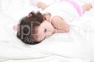 adorable toddler girl on the bed at home