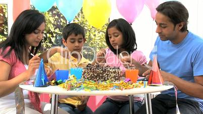 Young Ethnic Family Enjoying Birthday Cake