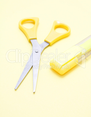 Yellow scissors and a marker