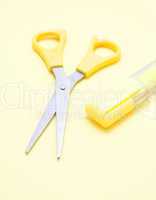 Yellow scissors and a marker