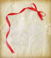 Red ribbon on old paper