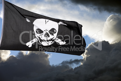 Jolly Roger (pirate flag) against storm clouds