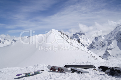 Snowboards against the top of mountain