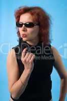 red haired woman with pistol