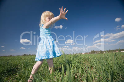 little girl on sunny meadow