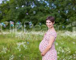Pregnant woman with soap bubbles