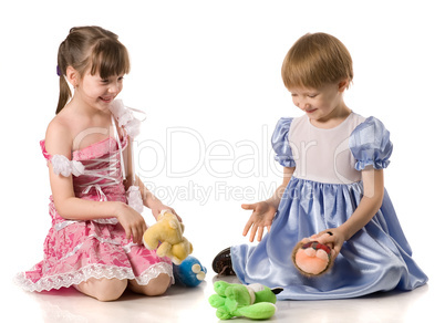 Two girls playing with toys on the floor