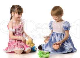 Two girls playing with toys on the floor