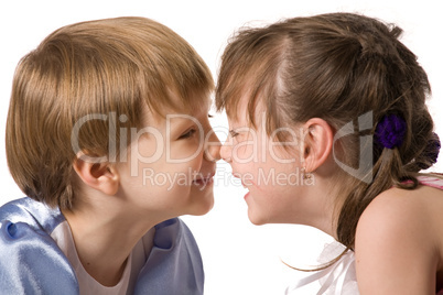 Two smiling little girls sit face to face