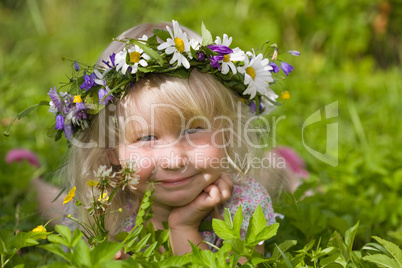 happy little girl on green meadow