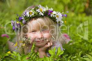 happy little girl on green meadow
