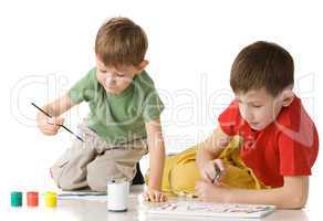 two boys drow on floor