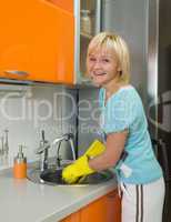 Young woman washing dishes