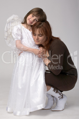 toddler in angel dress with her mother