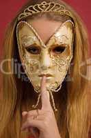 young woman in mask shows gesture of silence