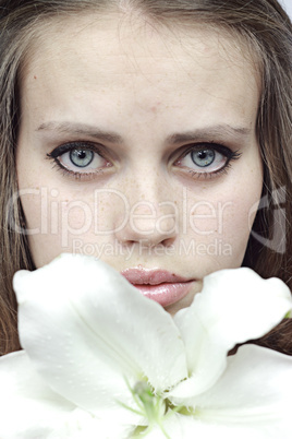 girl behind a snow-white lily