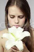 girl smells a lily