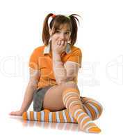 Adult girl with a two pony-tail sits on a floor