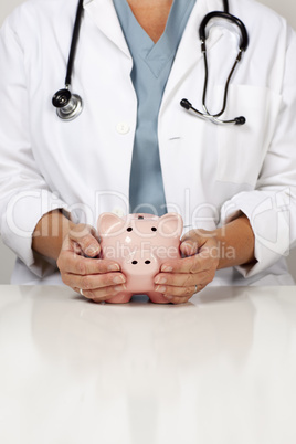 Doctor with Caring Hands on a Piggy Bank