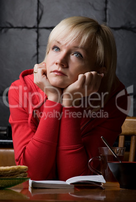 thoughtful girl is in a cafe