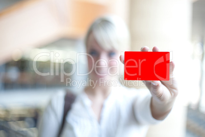 woman holds an identification card