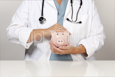 Doctor with Stethoscope Holding Piggy Bank Abstract