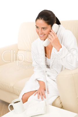 Attractive mid-aged woman on phone wear bathrobe