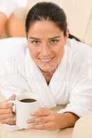 Attractive woman in white bathrobe hold coffee