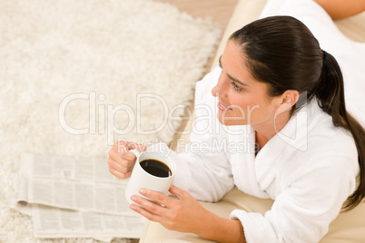 Attractive woman in white bathrobe hold coffee