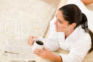 Attractive woman in white bathrobe hold coffee