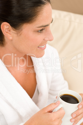 Attractive woman in white bathrobe with coffee