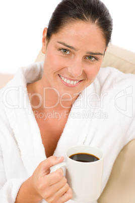 Attractive woman in white bathrobe with coffee