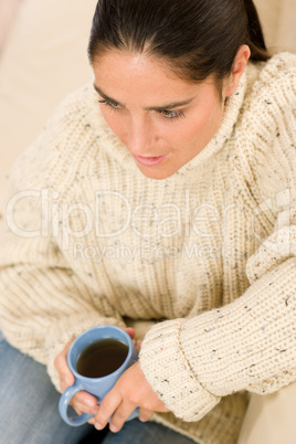 Winter portrait of happy woman holding cup of coffee