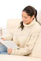 Attractive mid-aged woman read book on sofa