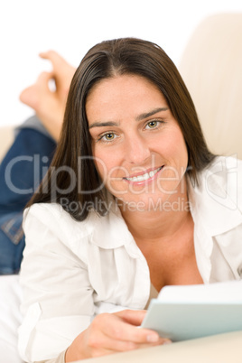 Attractive mid-aged woman read book on sofa