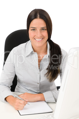 Successful business woman at office with notepad