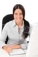 Successful business woman at office with notepad