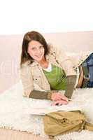Student female teenager read books lying floor