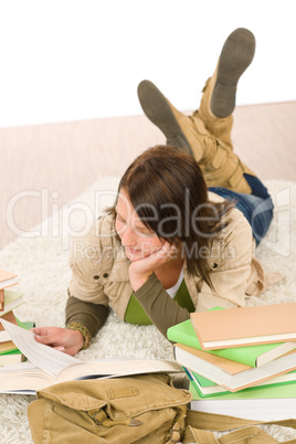 Student female teenager read homework with book