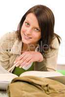 Student female teenager write homework with book