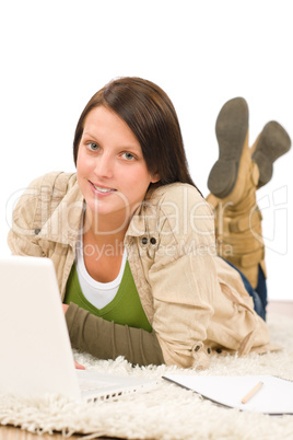 Student teenager girl typing laptop lying floor