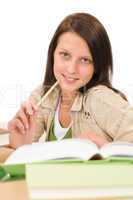 Student teenager girl write homework with book
