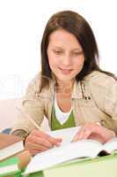 Student teenager girl write homework with book