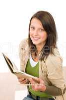 Student teenager girl holding books looking up