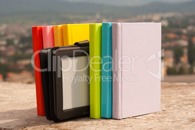 Row of colorful books with electronic book reader