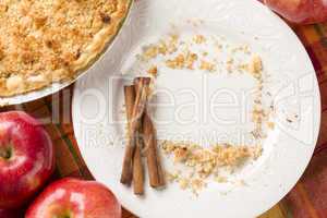 Pie, Apples, Cinnamon Sticks and Copy Spaced Crumbs on Plate